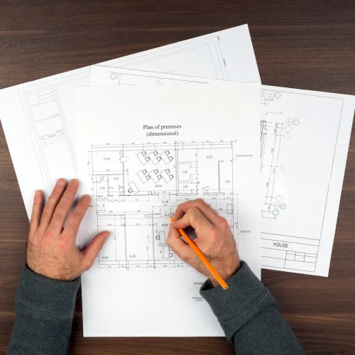 mans-hands-drawing-drafts-on-wooden-table-2025-10-16-13-44-39-utc.webp